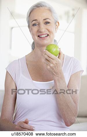Senior Woman Eating Green Apple View Large Photo Image Stock Photo - Senior Woman Eating Green Apple. Fotosearch