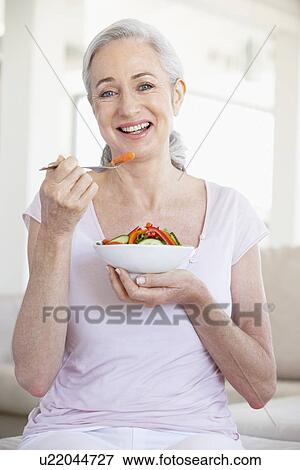 Stock Photo - Senior Woman Eating Salad. Fotosearch