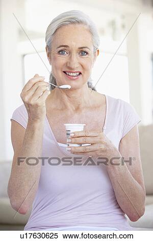 Senior Woman Eating Yogurt View Large Photo Image Stock Photography - Senior Woman Eating Yogurt. Fotosearch