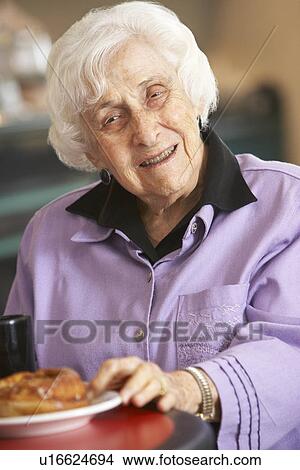 Picture - Senior woman having morning tea. Fotosearch