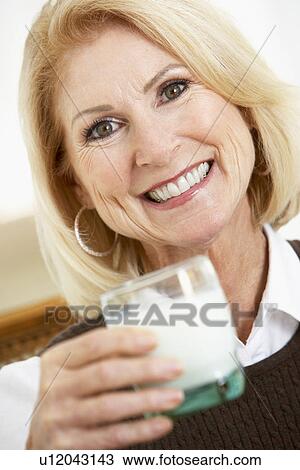 Senior Woman Holding A Glass Of Milk, Smiling At The Camera View Large Photo Image Stock Image - Senior Woman Holding A Glass Of Milk, Smiling At The Camera. Fotosearch