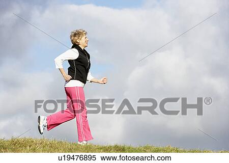 Stock Photography - Senior Woman Jogging In The Park. Fotosearch