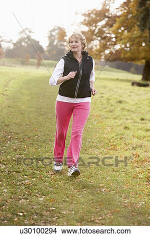 Senior Woman Power Walking In The Park View Large Photo Image Picture - Senior Woman Power Walking In The Park. Fotosearch