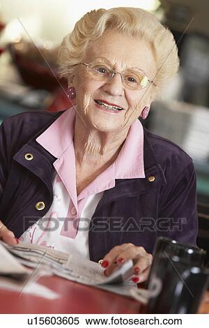 Senior woman reading newspaper View Large Photo Image Stock Photography - Senior woman reading newspaper. Fotosearch