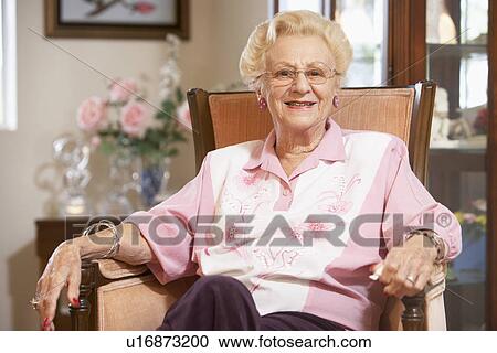 Senior woman relaxing in chair View Large Photo Image Stock Image - Senior woman relaxing in chair. Fotosearch
