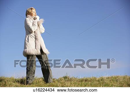 Picture - Senior Woman Standing In Park. Fotosearch