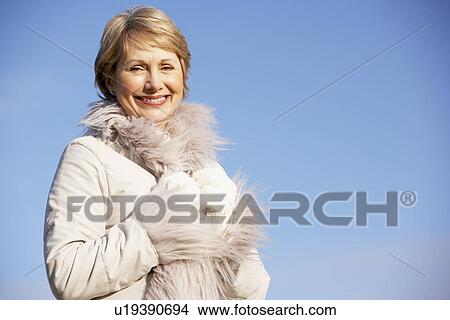 Picture - Senior Woman Standing In Park. Fotosearch