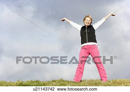 Senior Woman Standing In Park View Large Photo Image Stock Image - Senior Woman Standing In Park. Fotosearch