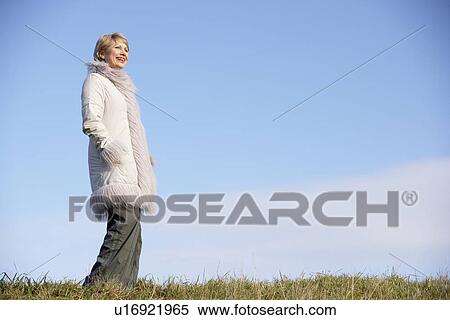 Stock Photography - Senior Woman Standing In Park. Fotosearch