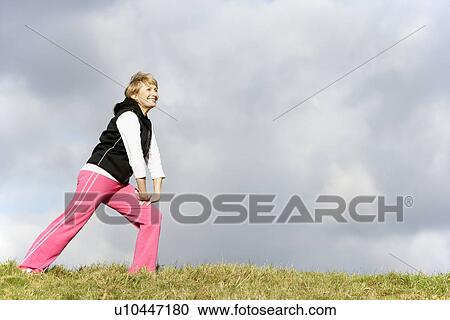 Senior Woman Stretching In Park View Large Photo Image Stock Image - Senior Woman Stretching In Park. Fotosearch