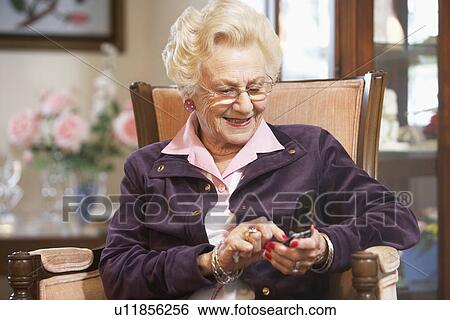 Senior woman text messaging View Large Photo Image Stock Photograph - Senior woman text messaging. Fotosearch