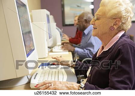 Stock Image - Senior woman using computer. Fotosearch
