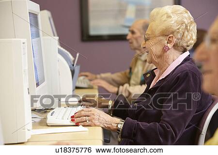 Senior woman using computer View Large Photo Image Stock Photograph - Senior woman using computer. Fotosearch