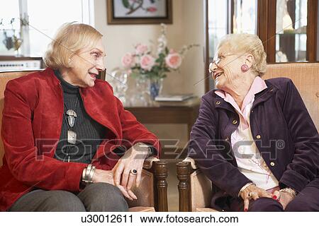 Stock Image - Senior women relaxing in armchairs. Fotosearch