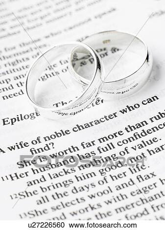 Silver Wedding Rings Resting On A Book View Large Photo Image Stock Image - Silver Wedding Rings Resting On A Book. Fotosearch