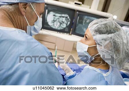 Stock Image - Surgeons During An Operation. Fotosearch