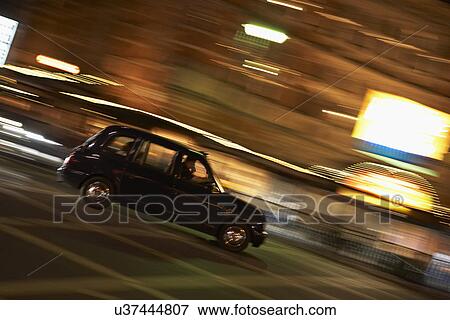 Taxi Driving Through Night Time Street View Large Photo Image Stock Photo - Taxi Driving Through Night Time Street. Fotosearch