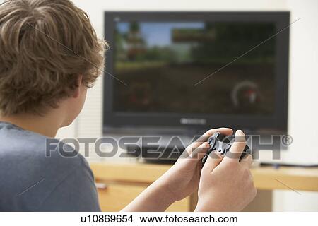 Picture - Teenage Boy Playing With Game Console. Fotosearch