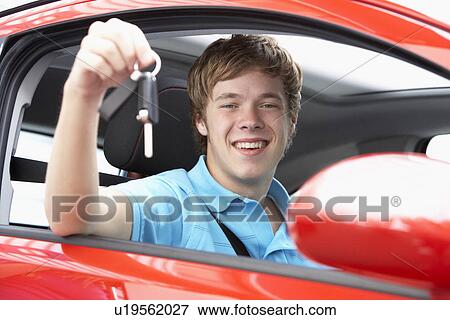 Stock Photo - Teenage Boy Sitting In Car Holding Car Keys. Fotosearch