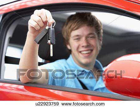 Teenage Boy Sitting In Car Holding Car Keys View Large Photo Image Stock Photo - Teenage Boy Sitting In Car Holding Car Keys. Fotosearch