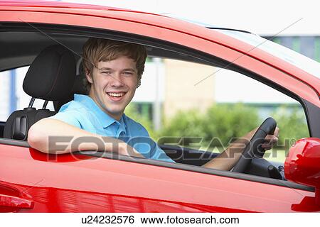 Stock Photograph - Teenage Boy Sitting In Car, Smiling At The Camera. Fotosearch