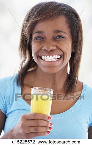 Stock Image - Teenage Girl Drinking Fresh Orange Juice. Fotosearch