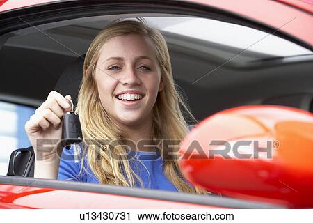 Teenage Girl Sitting In Car, Holding Car Keys And Smiling At The Camera View Large Photo Image Stock Image - Teenage Girl Sitting In Car, Holding Car Keys And Smiling At The Camera. Fotosearch