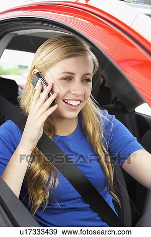 Stock Photo - Teenage Girl Sitting In Car Talking On Cellphone. Fotosearch