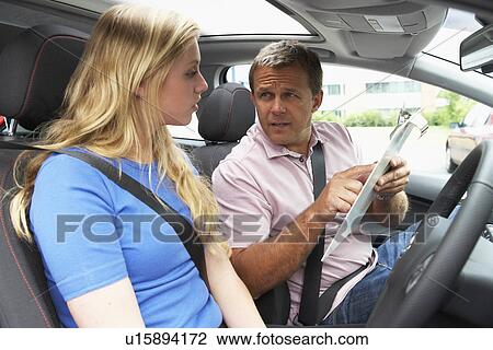 Stock Image - Teenage Girl Taking A Driving Lesson. Fotosearch