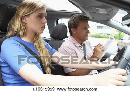 Stock Photo - Teenage Girl Taking A Driving Lesson. Fotosearch