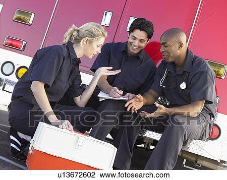 Three paramedics chatting and doing paperwork, sitting by their ambulance View Large Photo Image Stock Image - Three paramedics chatting and doing paperwork, sitting by their ambulance. Fotosearch