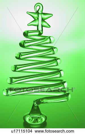 Picture - Tree Shaped Christmas Decoration Against Green Background. Fotosearch