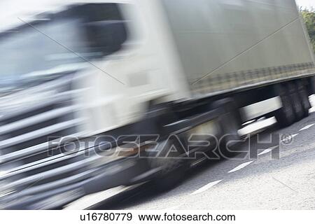 Stock Photo - Truck Driving Along The Road. Fotosearch