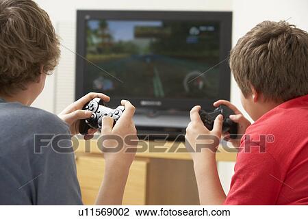Stock Image - Two Boys Playing With Game Console. Fotosearch