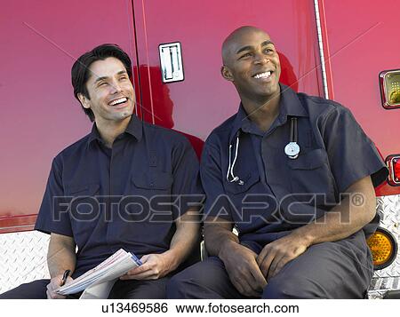 Two paramedics cheerfully doing paperwork, sitting by their ambulance View Large Photo Image Stock Photograph - Two paramedics cheerfully doing paperwork, sitting by their ambulance. Fotosearch