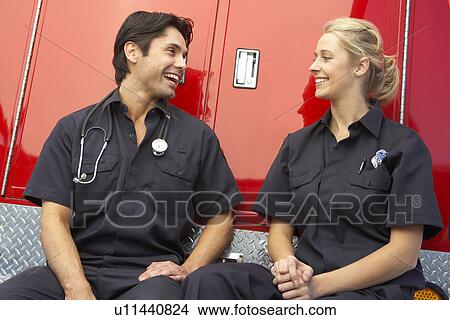 Picture - Two paramedics laughing together. Fotosearch
