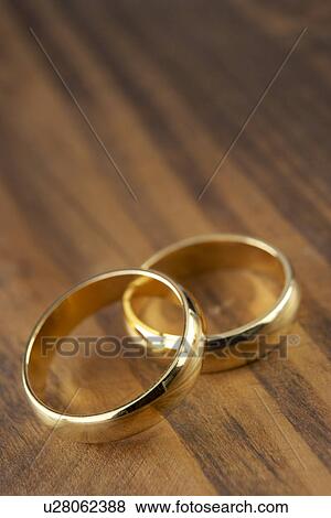 Stock Photo - Two Wedding Rings Resting Together. Fotosearch