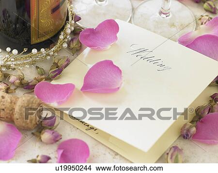 Wedding Invitation Next To Champagne Bottle Surrounded By Flower Petals View Large Photo Image Picture - Wedding Invitation Next To Champagne Bottle Surrounded By Flower Petals. Fotosearch
