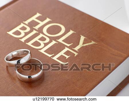 Wedding Rings Resting On A Holy Bible View Large Photo Image Stock Image - Wedding Rings Resting On A Holy Bible. Fotosearch