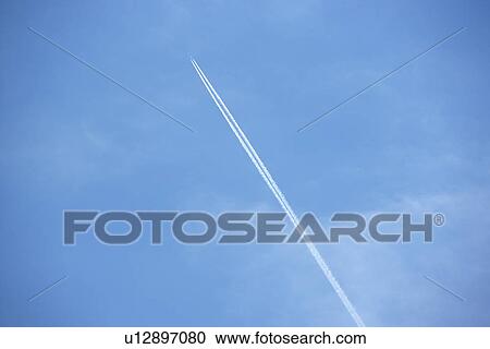 White Condensation Trail From A Jet As It Flies Across A Blue Sky View Large Photo Image Stock Image - White Condensation Trail From A Jet As It Flies Across A Blue Sky. Fotosearch