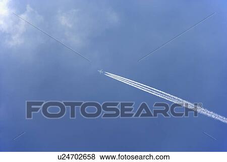 White Condensation Trail From A Commercial Airplane As It Flies Across A Blue Sky View Large Photo Image Stock Photo - White Condensation Trail From A Commercial Airplane As It Flies Across A Blue Sky. Fotosearch