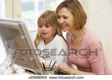 Stock Photography - Woman And Daughter Using Computer. Fotosearch