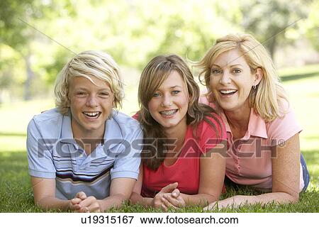 Woman And Her Teenage Children Lying On Grass View Large Photo Image Stock Photo - Woman And Her Teenage Children Lying On Grass. Fotosearch