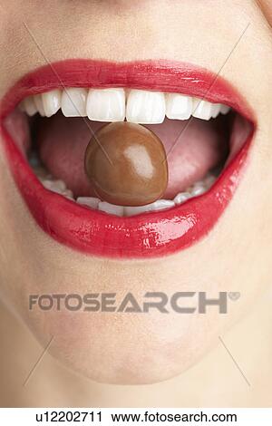 Woman Biting Chocolate View Large Photo Image Stock Image - Woman Biting Chocolate. Fotosearch