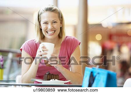 Woman Eating A Piece Of Cake At The Mall View Large Photo Image Stock Photo - Woman Eating A Piece Of Cake At The Mall. Fotosearch