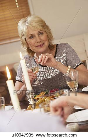 Stock Photography - Woman Eating Dinner At Home. Fotosearch