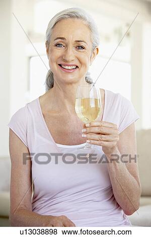 Woman Enjoying A Glass Of White Wine View Large Photo Image Stock Photo - Woman Enjoying A Glass Of White Wine. Fotosearch