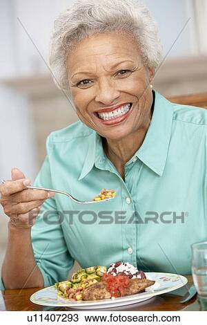 Woman Enjoying A Meal At Home View Large Photo Image Stock Image - Woman Enjoying A Meal At Home. Fotosearch