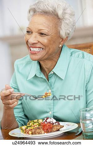 Woman Enjoying A Meal At Home View Large Photo Image Stock Image - Woman Enjoying A Meal At Home. Fotosearch