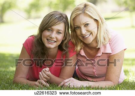 Woman Lying On The Ground With Her Teenage Daughter View Large Photo Image Stock Image - Woman Lying On The Ground With Her Teenage Daughter. Fotosearch